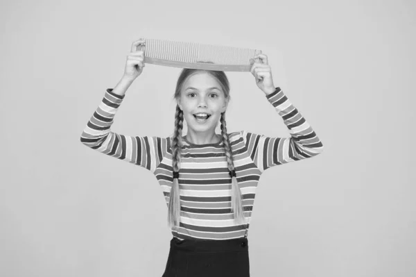 Professional equipment. Comb for tangled hair. Hairdresser supplies. Large comb. Girl long hair hold enormous comb. Hairdresser salon. Combing hair. Cheerful happy smiling little kid with giant comb — Stock Photo, Image