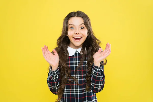Amazing news. Happy smiling kid portrait. Emotions emotional expression. Just happy. Small girl classy checkered dress. Child long curly hair. Happy schoolgirl stylish uniform. Childhood concept — Stock Photo, Image