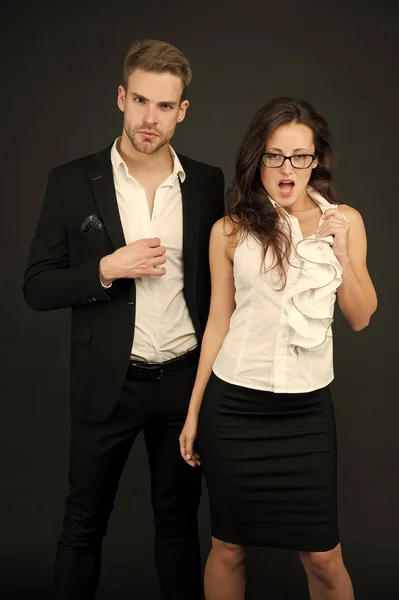 How to attract a boss. Boss man and sensual female coworker in formalwear. Couple of handsome boss and sexy employee. Boss and subordinate on grey background. Business relationship