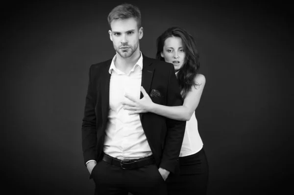 Turning your passion into business. Couple of business partners. Working couple on dark background. Couple in love in formal wear. Romantic couple of handsome man and sensual woman Stock Photo