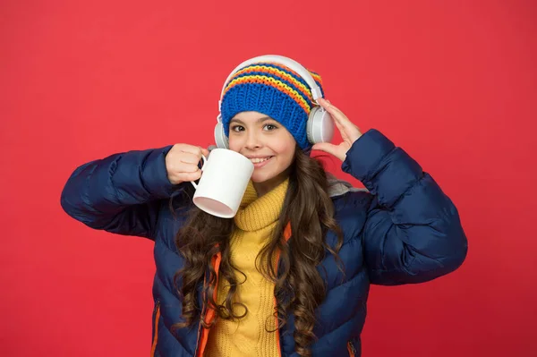 Take a sip. Happy child enjoy drinking tea or coffee. Little girl hold drinking mug. Healthy drinking habits. Drinking cocoa or chocolate. Music and hot drink. Winter holidays. Morning and breakfast