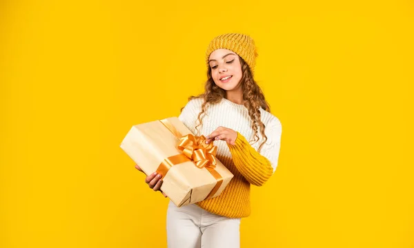 Año nuevo nuevos objetivos. Feliz Navidad y Año Nuevo. Regalo de Navidad en mano. Concepto de Navidad. Feliz niña sonriente con caja de regalo de Navidad. niño mantenga presente caja fondo amarillo — Foto de Stock