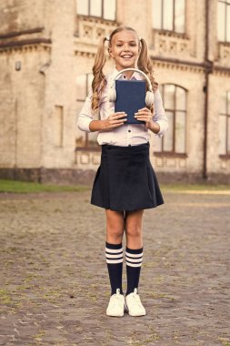 Knowledge assimilate better this way. Audio book concept. Listening school book. Digital technologies for learning. Elearning and modern methods. Girl cute schoolgirl hold book and headphones