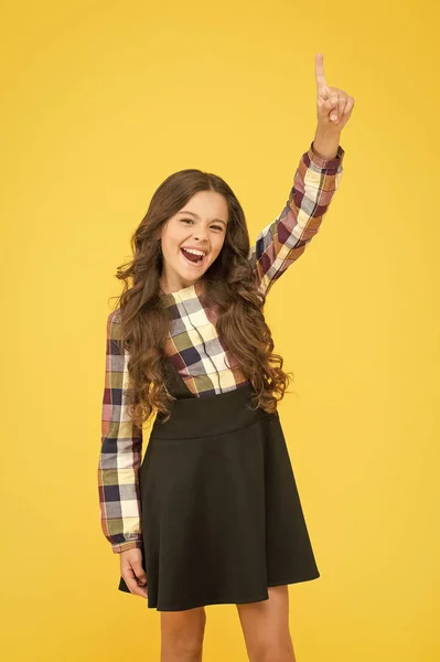 A new genius. Happy schoolgirl got genius idea. Genius little child pointing finger up. Wonder kid on yellow background. Genius in education. Future bright when school insight — Stock Photo, Image