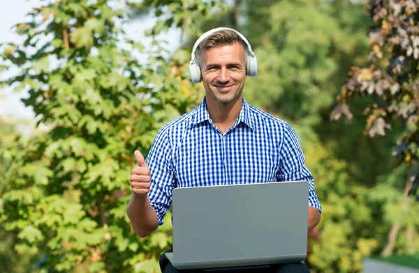 Always studying. Online communication. Personal blog social networks. Podcast business development. Podcast for manager. Musical service. Handsome man listening podcast while work with laptop