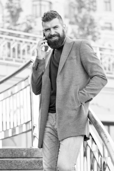 All he talks about is business. Business man. Bearded man has business talks on smartphone. Business communication. New technology. Modern life