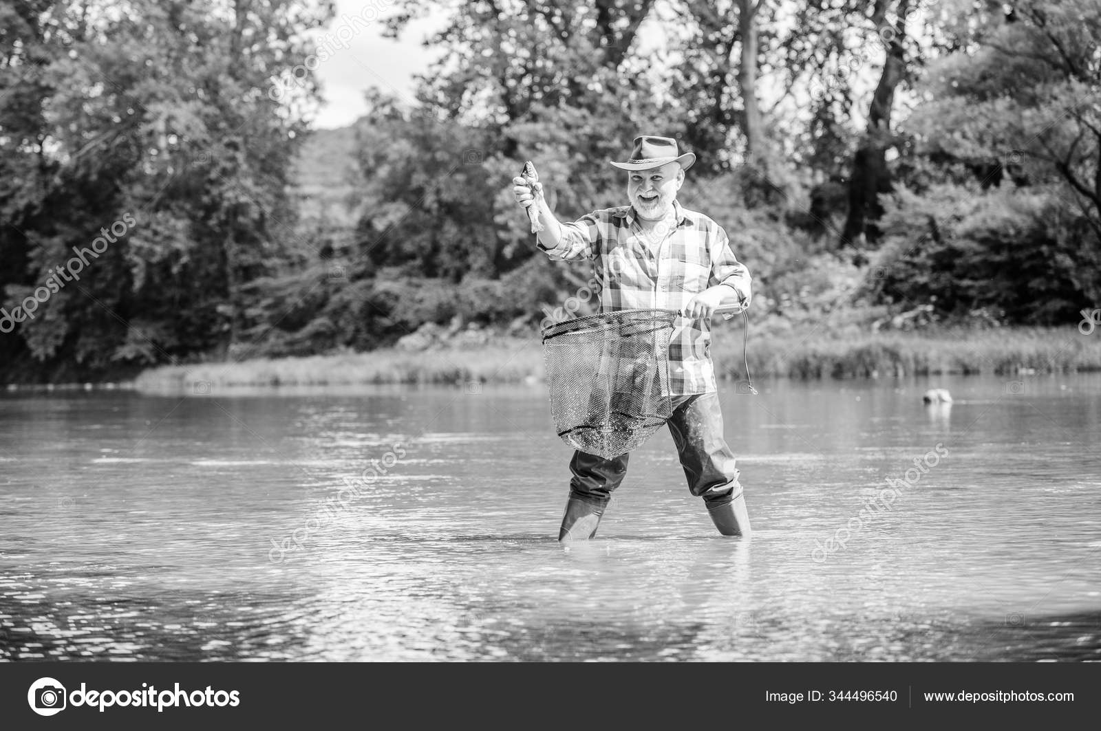 Retirement Is A Full Time Job. sport activity and hobby. Trout bait.  pothunter. man catching fish. retired fisher. big game fishing. mature man  fishing. summer weekend. fisherman with fishing rod Stock Photo