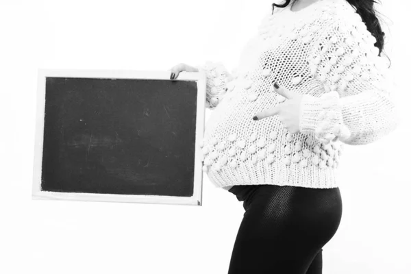 Female hands of pregnant woman holding black board — Stock Photo, Image