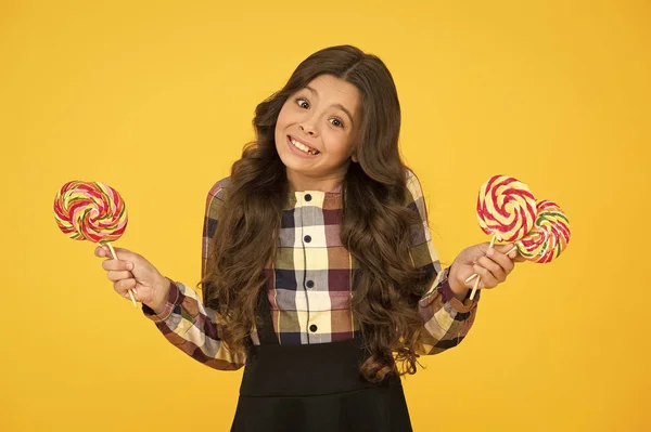 Taste the rainbow. Happy little girl hold swirl candy. Small child smile with hard candy on sticks. Candy shop. Candy made for me — Stock Photo, Image