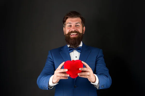 Mis mejores deseos de corazón sincero. Empresario con pajarita. Estética del símbolo del corazón. Día de San Valentín. Amor y relaciones. Día de la boda. El novio barbudo con traje formal. Salud. Corazón en las manos — Foto de Stock