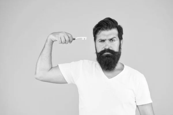 Mint paste. Healthy teeth. On guard of freshness. Teeth whitening procedure. Bearded man hold toothbrush yellow background. Hipster serious strict face cares hygiene. Brush teeth. Fresh breathe — Stock Photo, Image