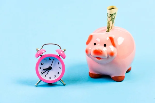 Banking account. Bankruptcy and debt. Pay for debt. Bank collector service. Credit debt. Economics and finance. It is time to pay. Piggy bank stuffed dollar cash and alarm clock. Financial crisis