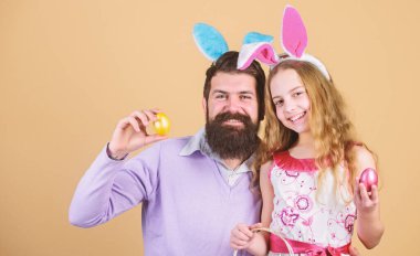 Umut ve yeniden doğuş. Mutlu baba ve çocuk renkli Paskalya yumurtaları ile. Mutlu bir aile. Aile Paskalya kutluyor. Aile baba ve kızı Paskalya bunny kulaklarında gülümse. Ailesi ne kadar da yıllık Paskalya yumurtası avı