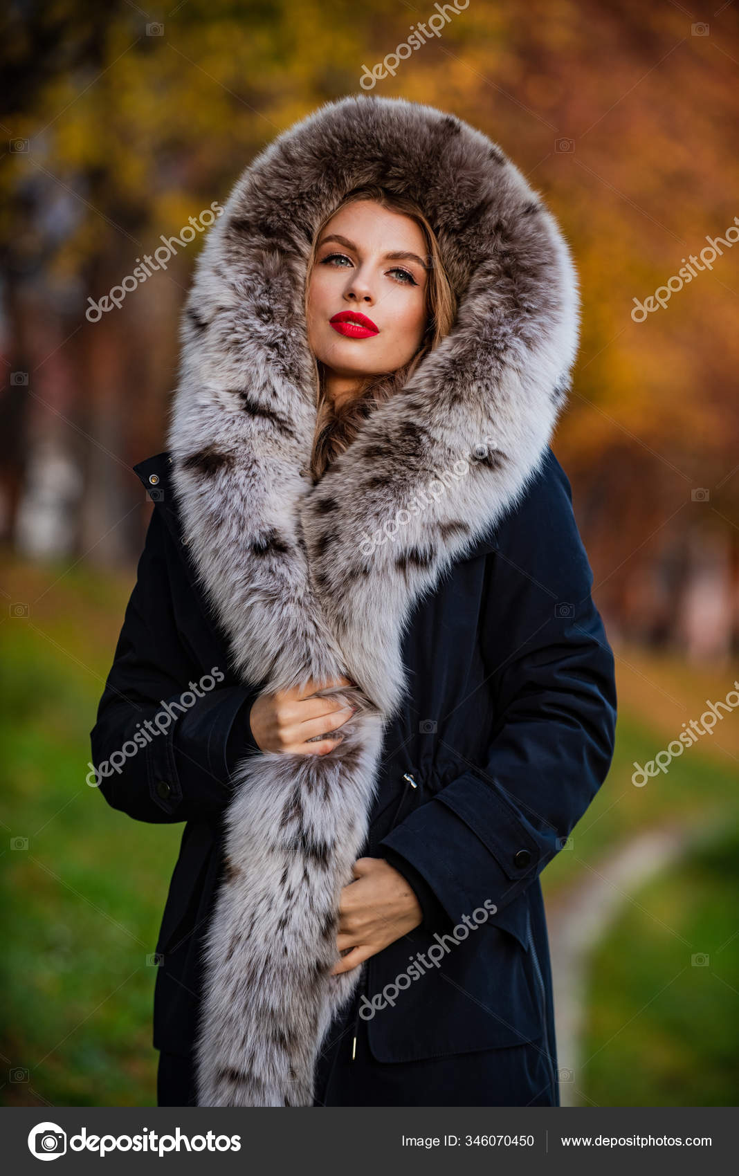 Classic parka coat has become wardrobe icon. Versatile functional and  stylish. Girl wear parka while walk park. Puffer jacket with hood. Woman  wear black parka fur hood. Youth hipster fashion concept Stock