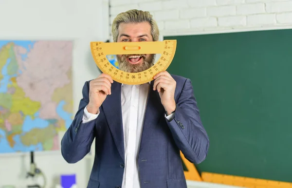 Handsome bearded man in classroom chalkboard. Study and education. Modern school. Knowledge day. Modern teaching method. Each School defines final examination sessions. Modern teacher lesson