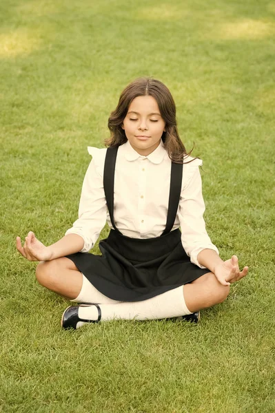Tune in for productive day. Yoga training. Kid adorable schoolgirl meditate. Meditation practice. Good vibes. Peaceful meditation. Learn meditation techniques. Girl school pupil sit on lawn