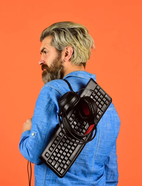 Cyber Championship. agile business. downloading music from internet. bearded man headphones and keyboard. Professional Gamer Playing Arcade computer game. chat online. Online Video Game