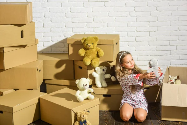 Moving in. Delivering service. Only necessary things. Playroom concept. Sweet home. Girl child relaxing after unpacking boxes. Feeling good at home. All she needs are toys. Home is where are my toys — Stock Photo, Image