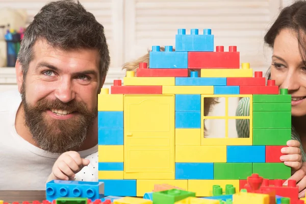 Child hides behind house made of plastic blocks. — 스톡 사진