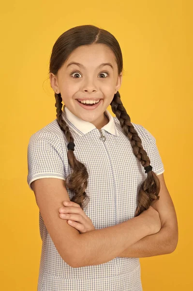 Smiling girl. Adorable schoolgirl yellow background. Little girl. Happy childrens day. Tidy girl nice hairstyle. Positive emotions. Emotional intelligence describes ability monitor your own emotions — Stock Photo, Image