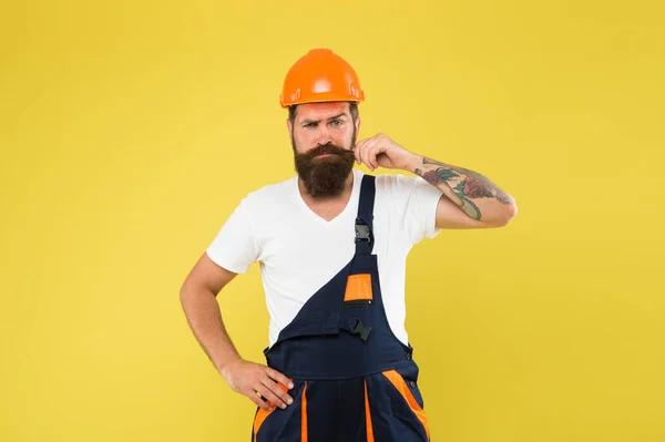 Improvement and renovation. Brutal man builder. Engineer builder in uniform. Man builder hard hat. Handyman at workshop. Creativity and practice. Polished approach. Craftsman keep head safe in helmet