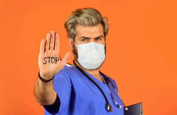 Danger zone. Man in medical lab. Protective mask. Open palm stop gesture. Stop epidemic. Virus concept. Epidemic infection. Critical number or density of susceptible hosts. Epidemic threshold