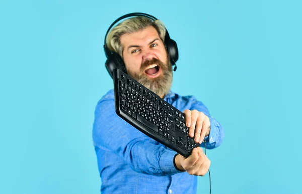 Gaming addiction. Man bearded hipster gamer headphones and keyboard. Play  computer games. Online gaming platform. Gaming modern leisure. Cyber sport  arena. Gaming PC build guide. Graphics settings Stock Photo by ©stetsik  510565044