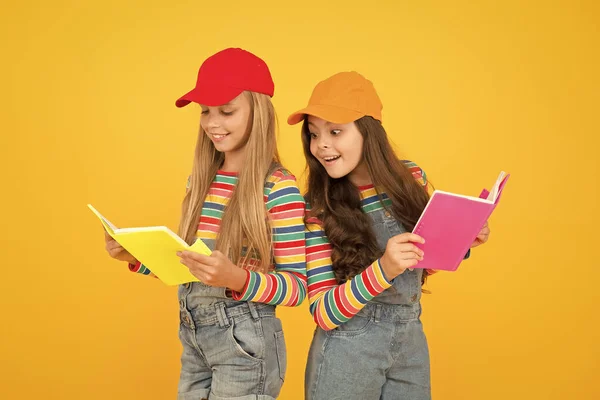 Kids girls with books study together. Study group can help solidify and clarify material. Back to school. Learning foreign languages. Effective study groups help students learn material deeper — Stock Photo, Image