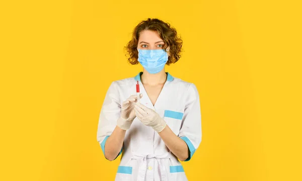 researcher holding flu vaccine. Doctor use syringe with vaccination for baby. wear respirator mask. medicine vial dose injection. medical injection against coronavirus. woman nurse with stethoscope