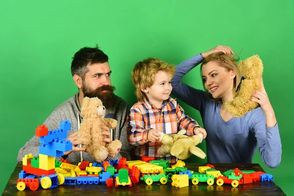 Man with beard, woman and boy play on green background