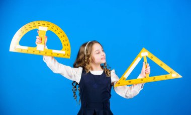 Öğrenci geometri okuyor. Çocuk okulu üniforması cetveli tutar. Okul eğitimi konsepti. Boyut ve boyut. Matematik öğren. Teoriler ve aksiyomlar. Zekice ve zekice bir fikir. Büyük cetveli kız