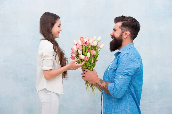 Little lady. Tender tulips for daughter. Man tulips bouquet. Father giving tulips girl. Dad with flowers. Birthday celebration. International womens day. Fathers day. Flower shop. Family tradition — Stock Photo, Image