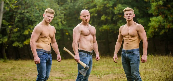 Never stop. Sports and leisure. mesomorph. three muscular men with axe. athletic man use ax. bodybuilders in jeans. Three sexy guys. brutal guys pose with naked torso. handsome guys with sexy body — Stock Photo, Image