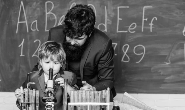 Samen scheikunde studeren. Alleen voor jongens. Persoonlijk voorbeeld. Chemisch experiment. Vader volgen in alles. Kennisdag. Mijn vader is wetenschapper. Leraar baardman vader en kind reageerbuizen — Stockfoto