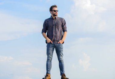 Mükemmel görüş. Göz sağlığı. Yakışıklı adam güneş gözlüğü takıyor. Moda güneş gözlüklü hippi. Modaya uygun güneş gözlükleri. Ultraviyole koruma kavramı. Erkek gözlük modeli açık havada mavi gökyüzü arkaplanı