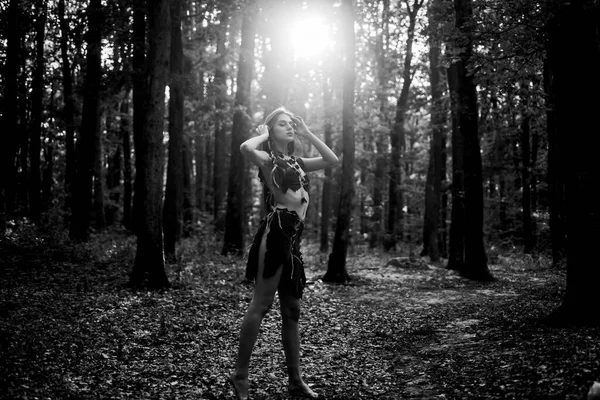 Wilderness of virgin woods. Female spirit mythology. She belongs tribe warrior women. Wild attractive woman in forest. Folklore character. Living wild life untouched nature. Sexy girl. Wild human