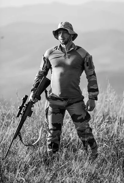 Ready to shoot. Army forces. Man military clothes with weapon. Focus and concentration experienced hunter. Brutal warrior. Rifle for hunting. Hunter hold rifle. Hunter mountains landscape background — Stock Photo, Image