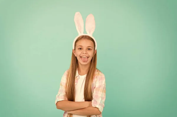 时尚配件复活节化装舞会。穿着复活节兔子的衣服看起来很漂亮可爱的小女孩戴兔子耳朵头带。小女孩显示舌头在复活节兔子的风格。有趣的可爱 — 图库照片