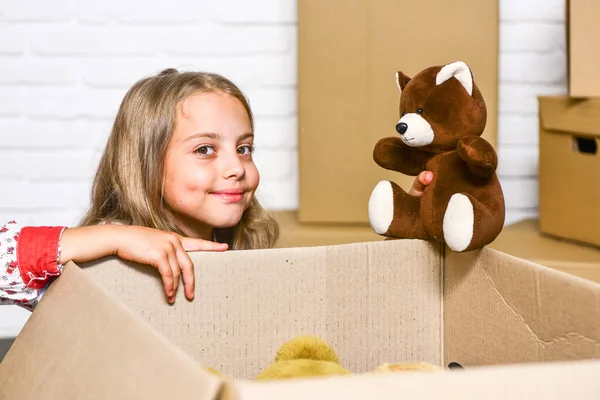 Delivering happiness. Delivering happy moments to childhood. Insurance post package. Relocating delivery services. Little child open post package with toys. Deliver your treasures. Storage for toys — Stock Photo, Image