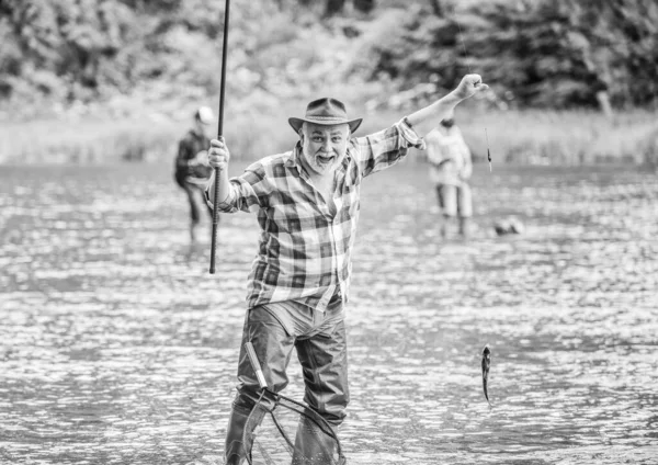 Best moment. mature man fishing. summer weekend. fisherman with fishing rod. pothunter. man catching fish. retired bearded fisher. big game fishing. sport activity and hobby. Trout bait — Stock Photo, Image