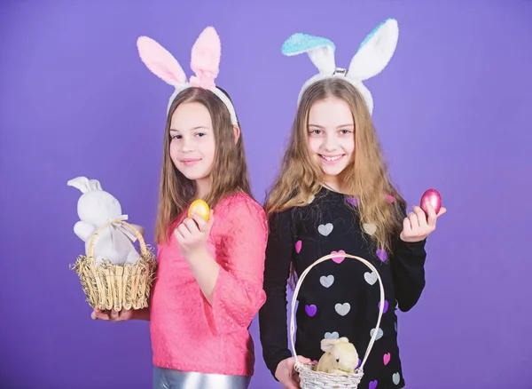 Spring holiday. Happy childhood. Easter day. Easter activities for children. Happy easter. Holiday bunny girls with long bunny ears. Egg and bunny holiday attribute. Sisters celebrate easter