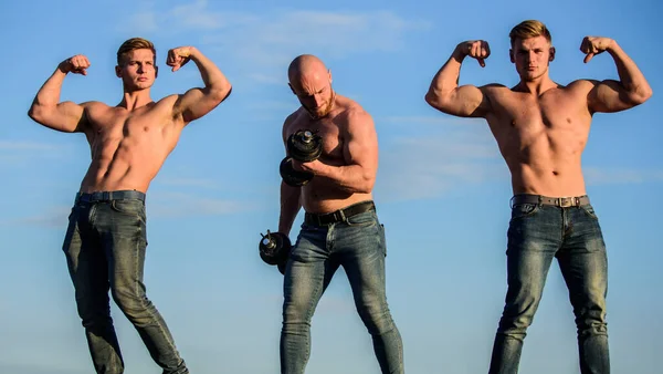 More strength more muscle. Body uses protein to build new muscle. Strong men blue sky background. Group muscular men. Athletic bodybuilders. Sport concept. Muscular body. Muscular means powerful