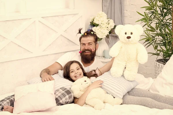 Family day. My family. father and daughter having fun. family bonding time. i love my daddy. happy morning together. funny pajama party. small girl with bearded father in bed. weekend at home