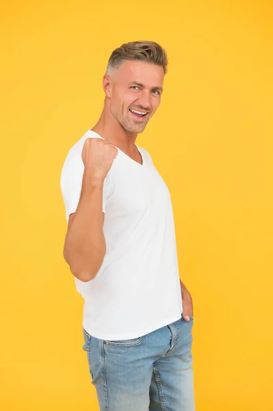 Potere maschile. Felice uomo fissare braccio sfondo giallo. Bachelor mostra la forza muscolare. Stile casual e tendenze della moda. Potente e sicuro di sé. La fiducia è potere — Foto Stock