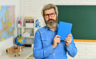 Edebiyat ve şiir. Okula dönelim. Sakallı adam kitap okuyor. Bilişsel gelişim. Öğretmen üniversitede çalışıyor. Eğitim konsepti. Öğrenmek için ilham verici. Modern okul. Özel ders. Okul projesi