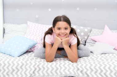 Pijamalı küçük kız yatmaya hazırlan. Rahatlayın ve uykuya geçişi kolaylaştırın. Uyku zamanı konsepti. Çocuklar için sakinleştirici aktivite. Yatmadan önce dinlenmenin yolları. Uykuya dalmak için gevşeme egzersizleri.