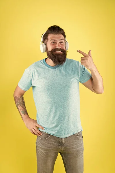 Sakallı adam müzik kablosuz gadget dinliyor. Temiz ses sunmak için tasarlanmış kablosuz kulaklıklar. Kablosuz yayın özgürlüğü size benzersizdir. Modern kablosuz kulaklıklar kullanarak Hipster mutlu — Stok fotoğraf