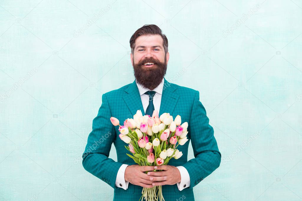 Hello summer. bearded man in formal suit greeting. happy valentines day. womens day gift tulips. spring flowers. Man with bouquet tulips. prepare for mothers day holiday. flower surprise for her