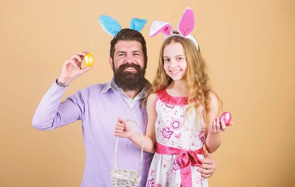 Happy family. Happy family celebrating Easter. Happy father and child with colored Easter eggs. Family of father and daughter smiling in Easter bunny ears. Happy family having fun on Easter. Egg hunt — Stock Photo, Image