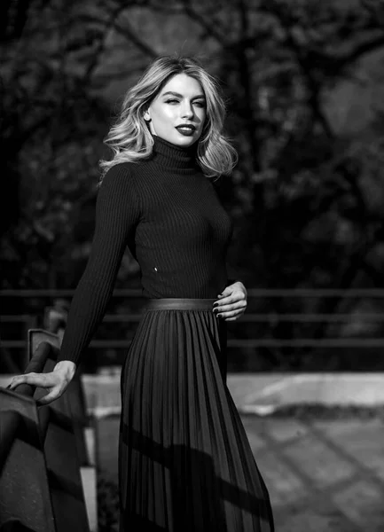 Follow me. haidresser and makeup. fall fashion season. autumn woman curly hair outdoor. girl in corrugated skirt and sweater. Pleated trend. girl long blond hair city walk. female beauty